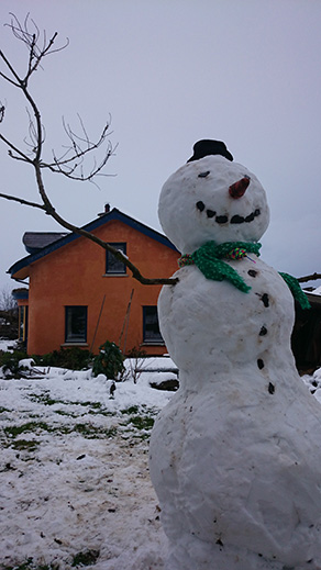 snowman at the mud and wood house